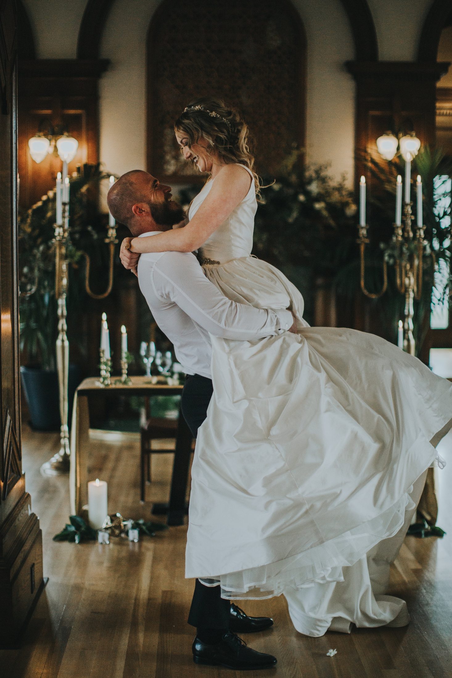 A joyful moment beside the candelabras.